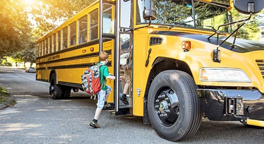 child getting on schoolbus